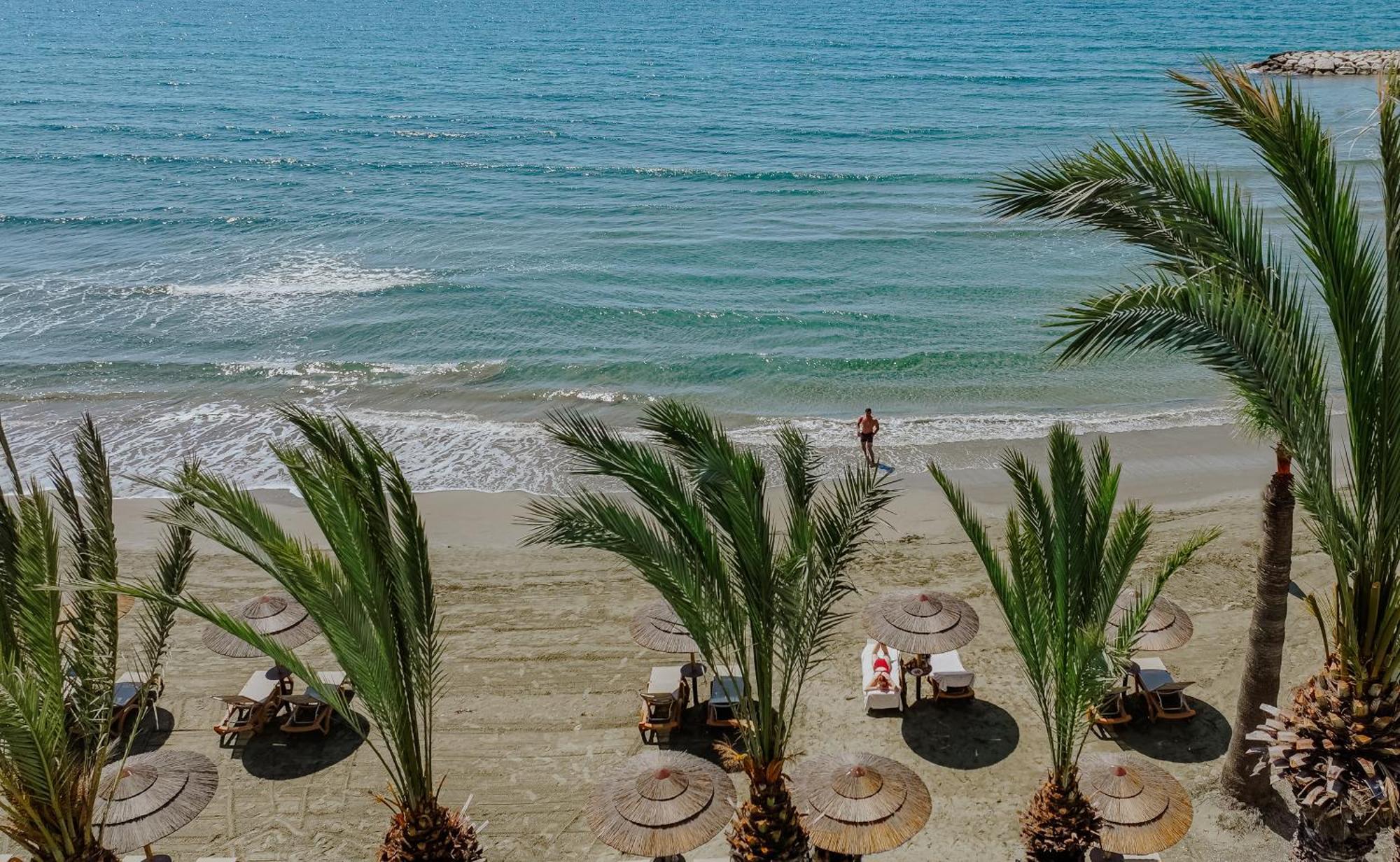 Golden Bay Beach Hotel Larnaca Exteriör bild Palm trees on the beach